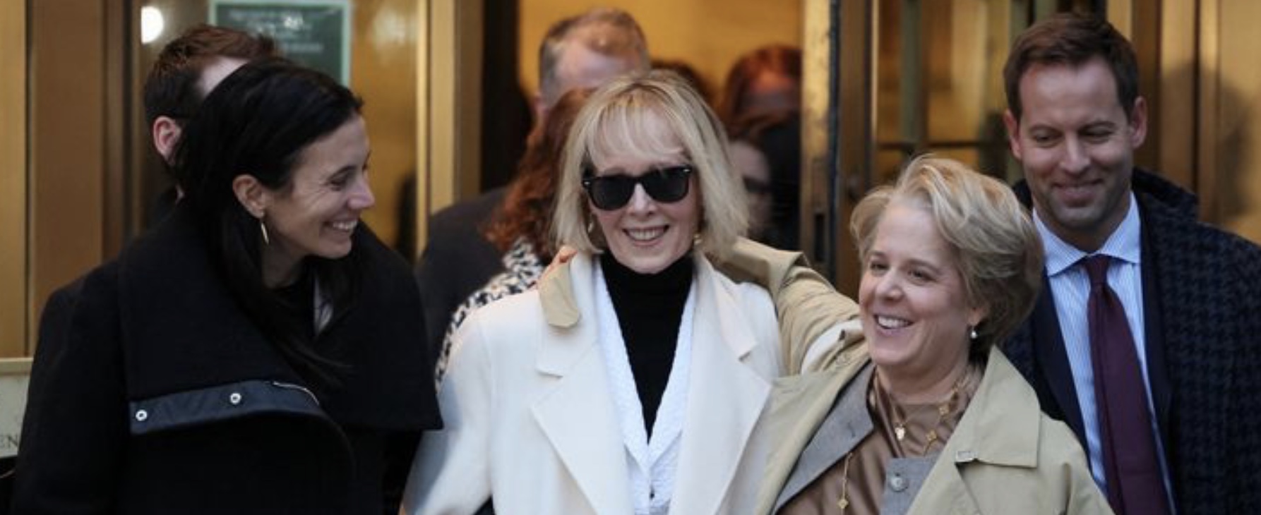 E. Jean Carroll and lawyers smiling after jury awarded her $83.3 million from Donald Trump. Image: SkyNews screengrab